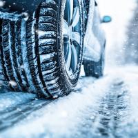 Car in the winter driving on snowy road